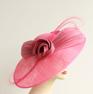 Nigel Rayment large disc hat on a band with abaca twist and large quills. A fabulous style for a wedding, the Races or other occasion where you want you turn heads! This deep pink colour is "Lipstick", also available in "Blush"style